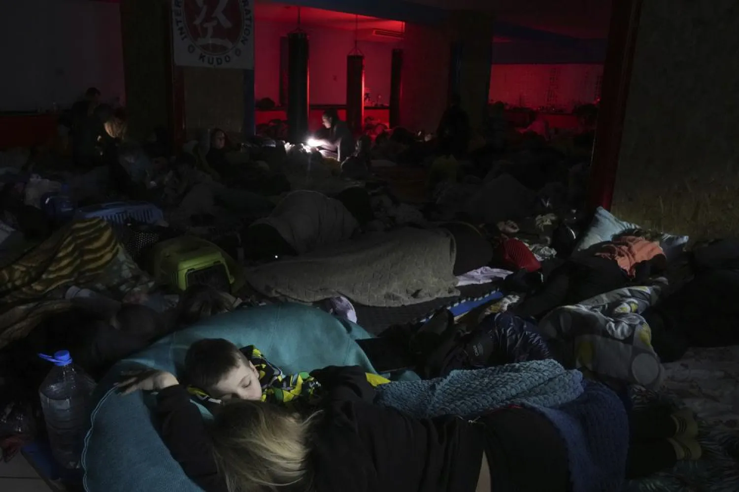 People sleep in the improvised bomb shelter in a sports center, which can accommodate up to 2,000 people, in Mariupol, Ukraine, late Sunday, Feb. 27, 2022. (AP)