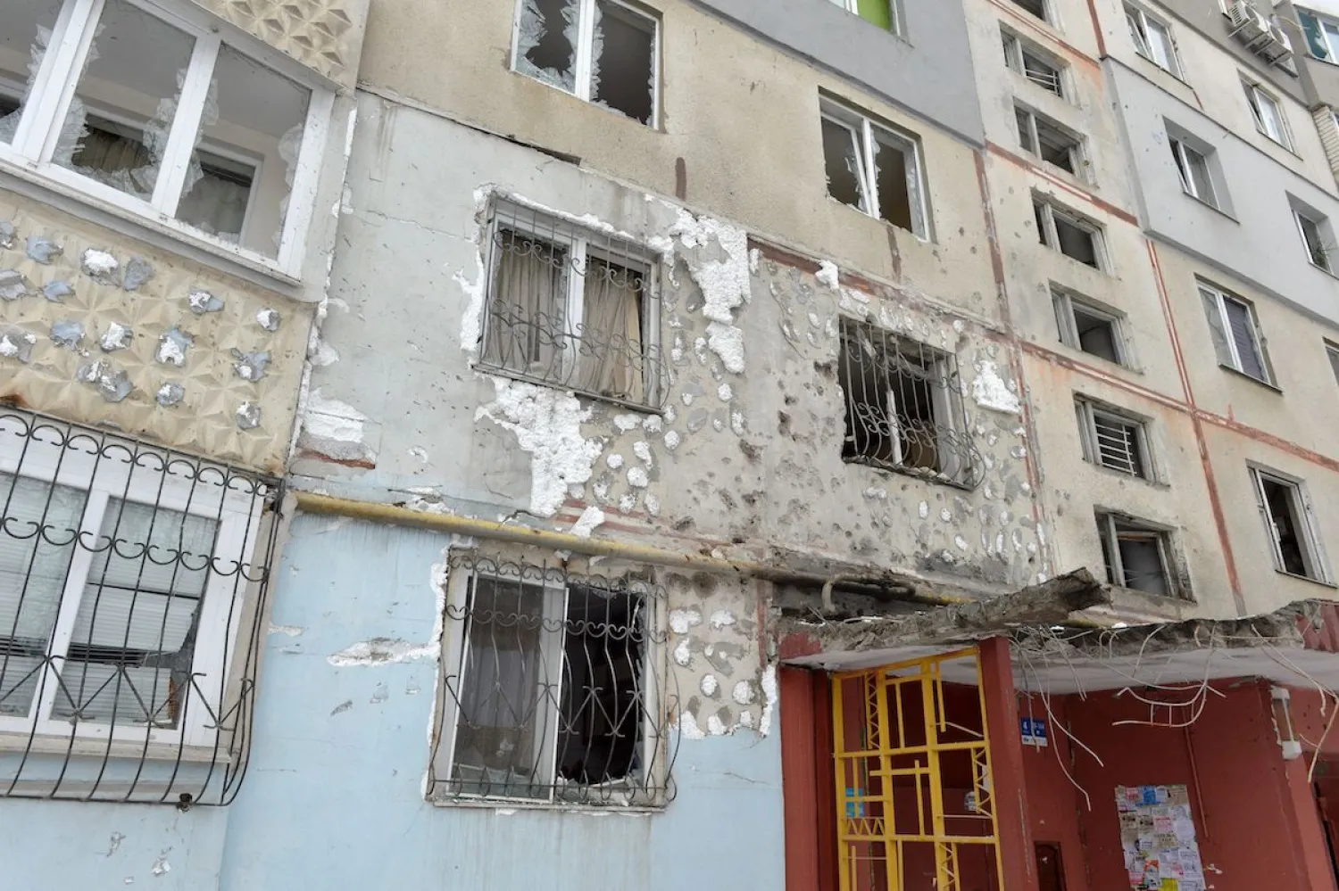 A view of a residential building damaged by recent shelling in Kharkiv on 26 February 2022. [SERGEY BOBOK/AFP via Getty Images]
