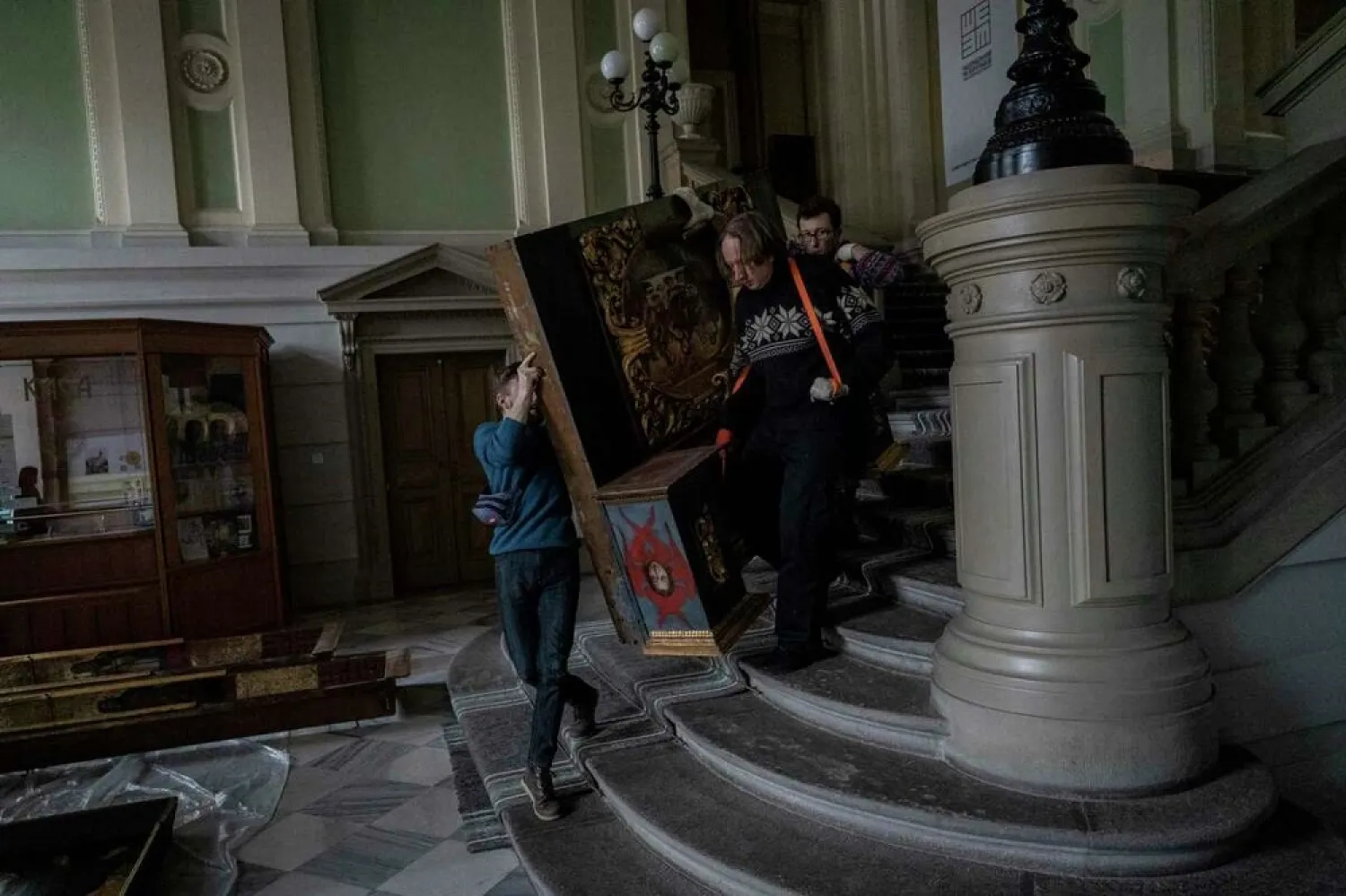 Workers move a baroque sacred art piece in the Andrey Sheptytsky National Museum as part of safety preparations in the event of an attack in the western Ukrainian city of Lviv, Friday, March 4, 2022. (AP)