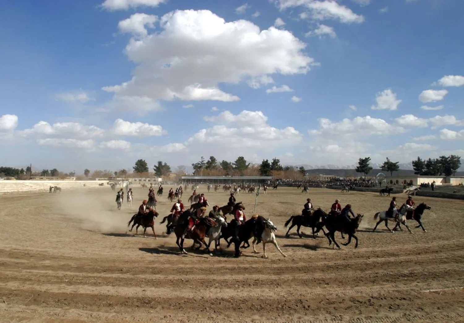 Afghan horse riders play a buzkashi game in Kabul February 27, 2004. (Reuters)