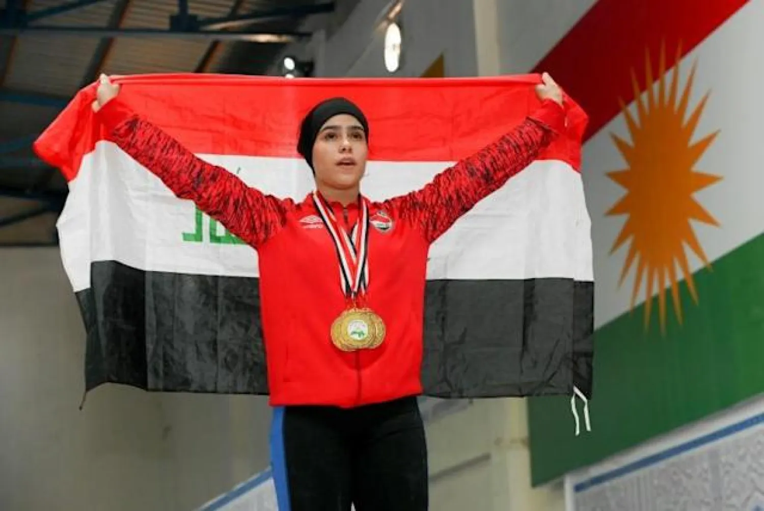 Ines Muhsin, posing with her medals, is one of three Kurdish Iraqi sisters who have helped place Iraq squarely on the map of Middle East weightlifting - AFP