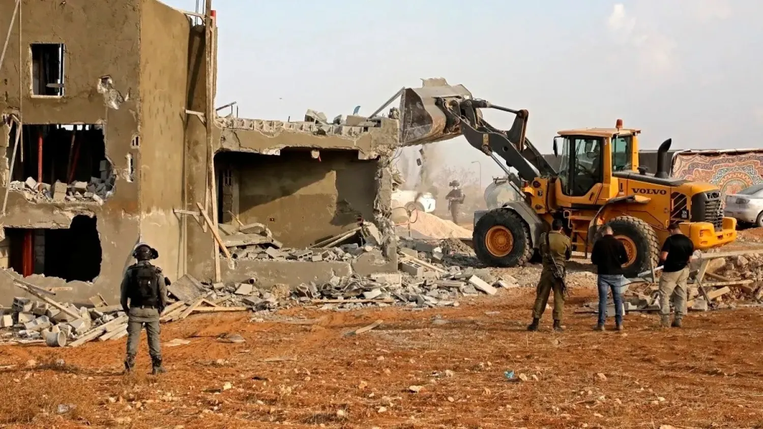 Israeli machinery demolish a Palestinian house located within the area C in a village south of Yatta in the southern area of the West Bank town of Hebron, on November 2, 2020. (AFP)