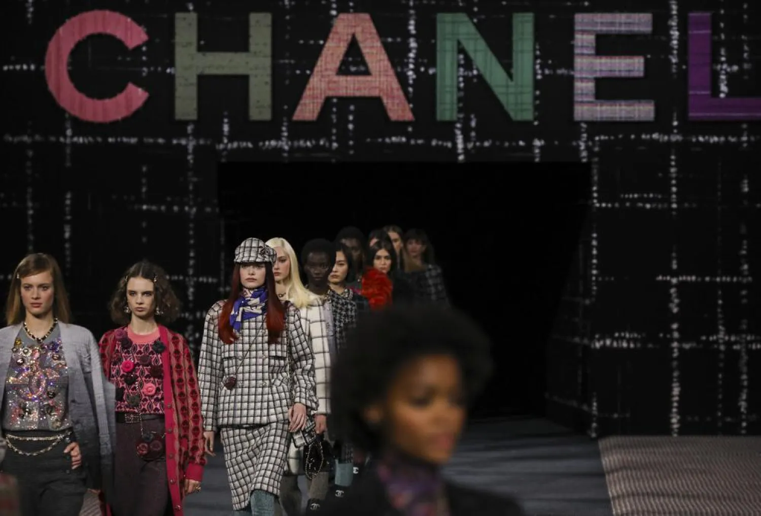 Models wear creations as part of the Chanel Ready To Wear Fall/Winter 2022-2023 fashion collection, unveiled during the Fashion Week in Paris, Tuesday, March 8, 2022. (AP)