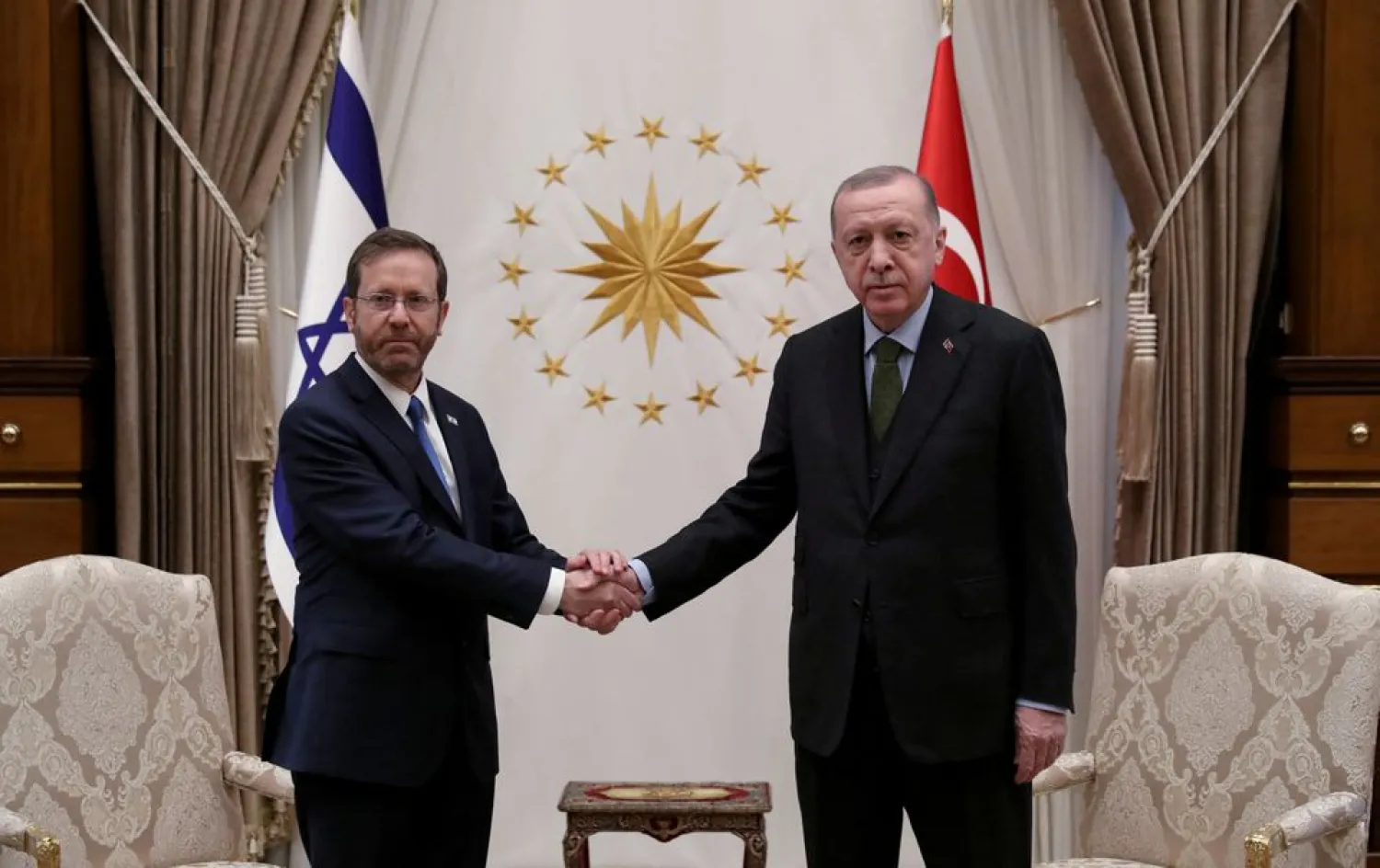 Turkish President Tayyip Erdogan shakes hands with his Israeli counterpart Isaac Herzog during their meeting in Ankara, Turkey March 9, 2022. (Presidential Press Office/Handout via Reuters)

