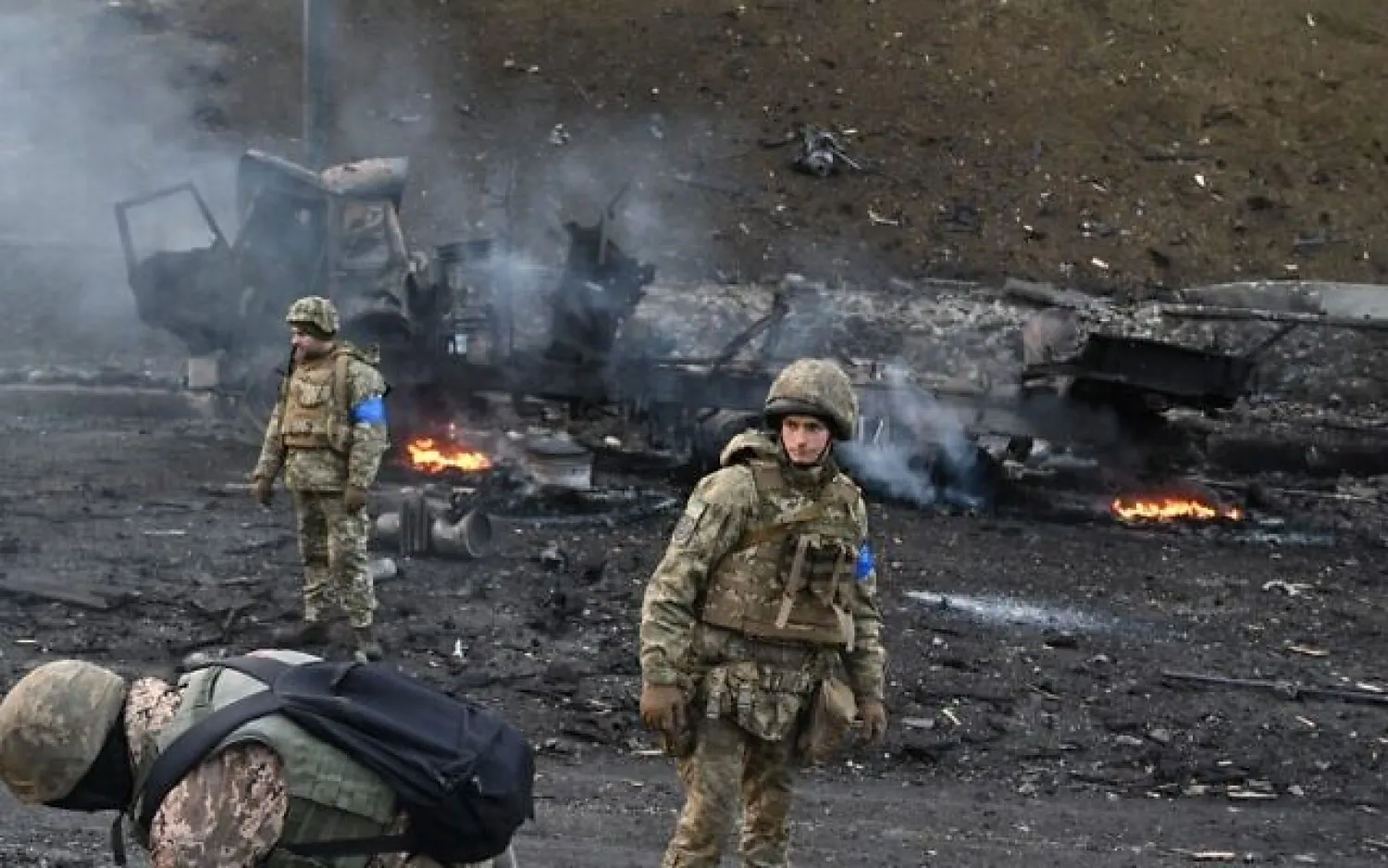 Ukrainian service members look for and collect unexploded shells after fighting with Russian troops in the Ukrainian capital of Kyiv on the morning of February 26, 2022. (Sergei Supinsky/AFP)
