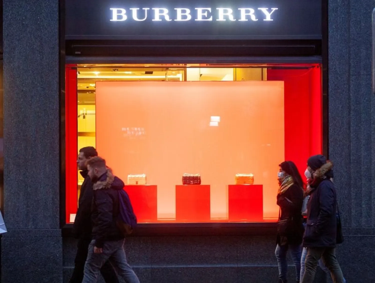 Shoppers walk past a store of fashion company Burberry, amid the spread of the coronavirus disease (COVID-19), in Zurich, Switzerland December 11, 2021. (Reuters)