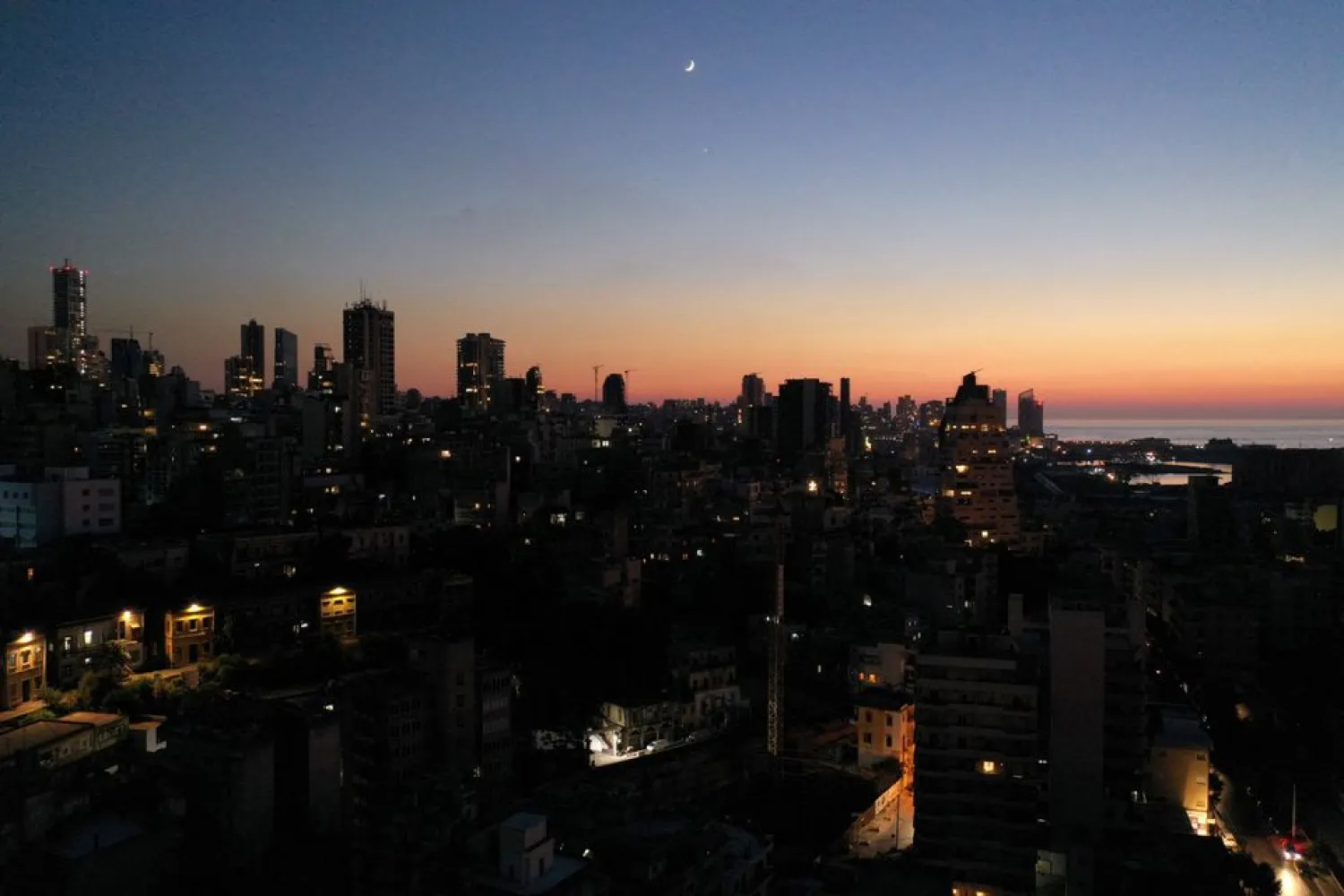 Unlit buildings are seen during a partial blackout in Beirut, Lebanon August 11, 2021. REUTERS/Issam Abdallah/File Photo
