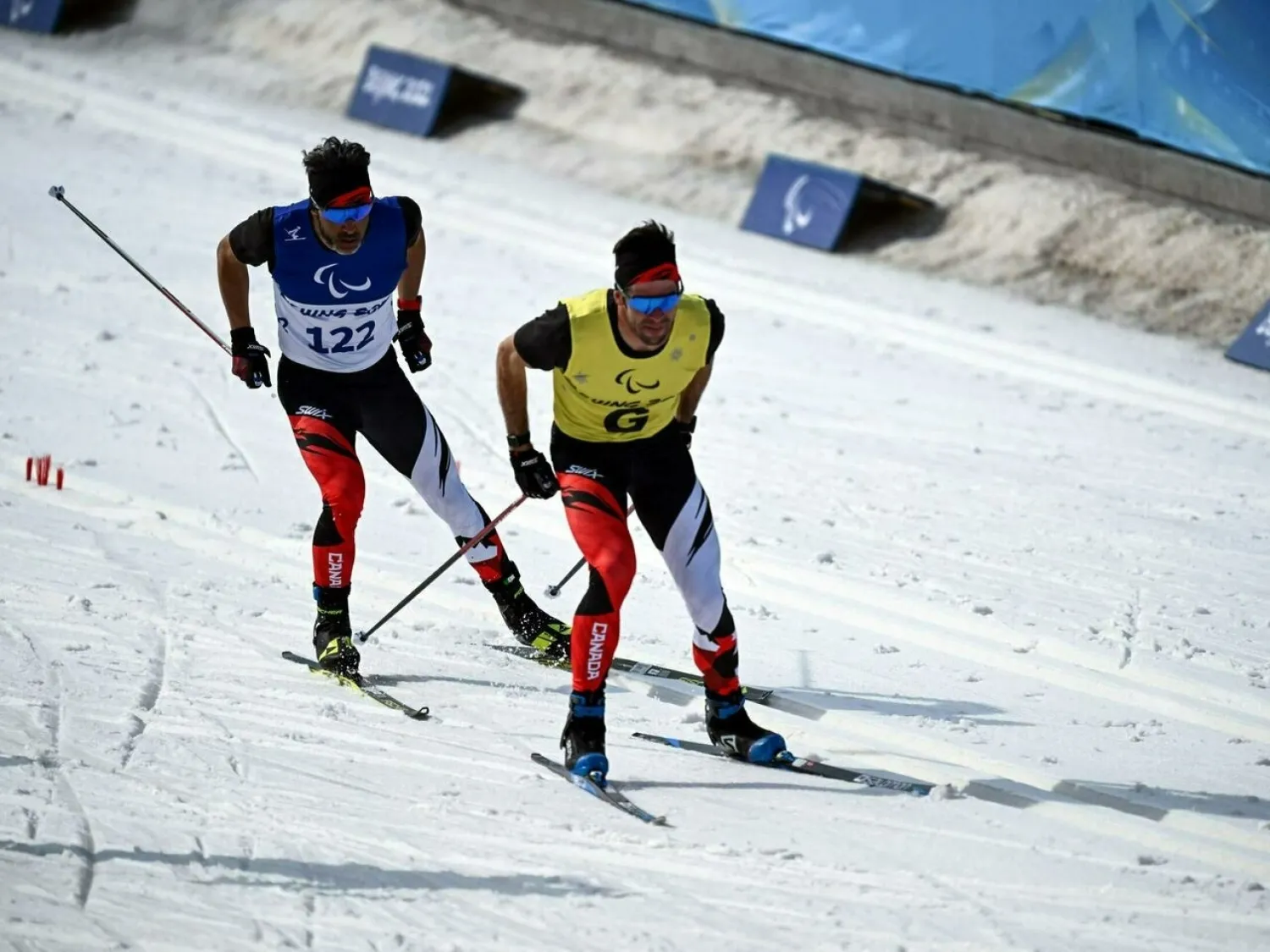 File Photo: Canada's Brian McKeever (left) has already bagged two titles in the visually impaired sprint and long-distance events this week at Zhangjiakou. LILLIAN SUWANRUMPHA AFP
