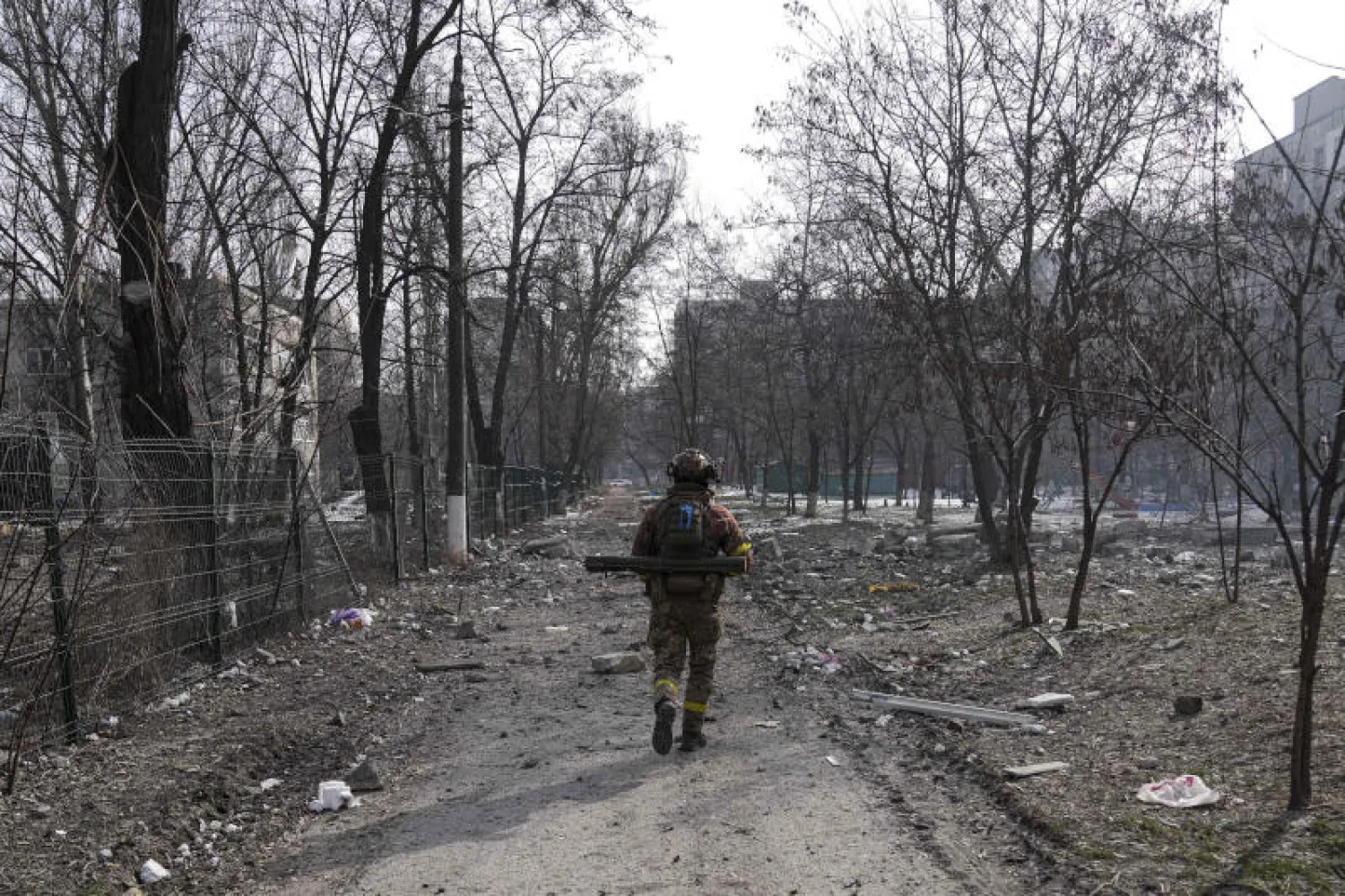 جندي أوكراني يسير في مدينة ماريوبول (أ.ب)
