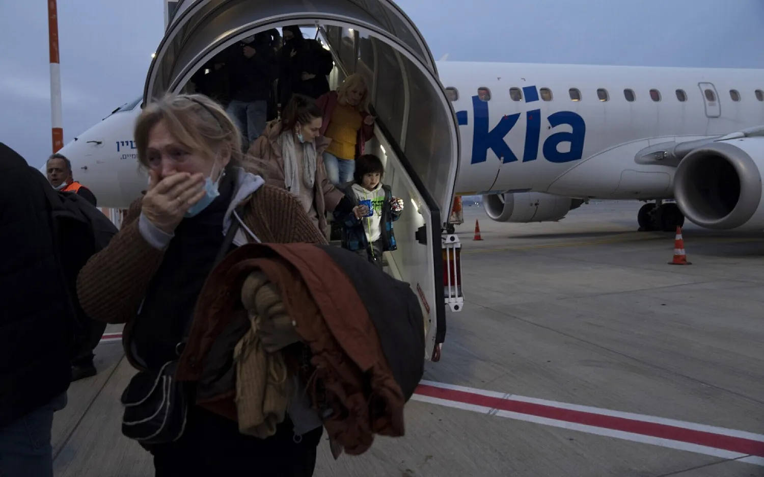 Ukrainians disembark from a special flight to Israel from Romania upon landing at Ben Gurion Airport, March 8, 2022 (AP)