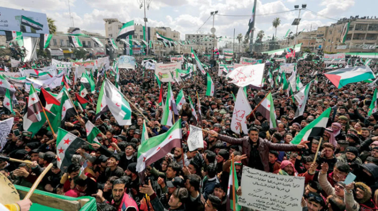 مظاهرات في إدلب أمس بمناسبة الذكرى الـحادية عشرة لبدء الاحتجاجات (رويترز)