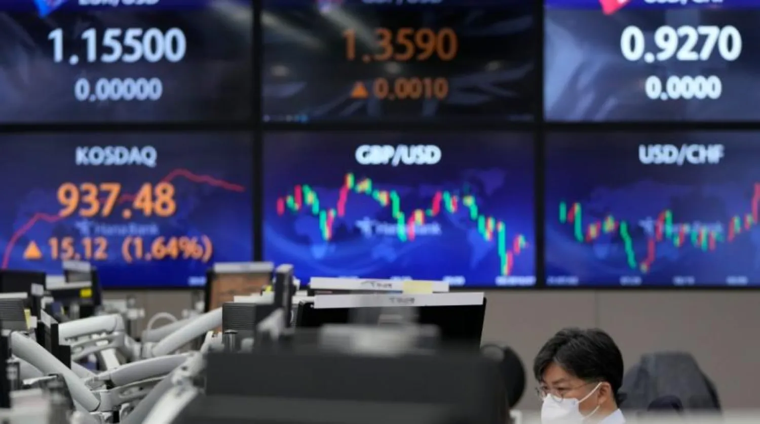 File Photo: A currency trader watches computer monitors near the screens showing the Korean Securities Dealers Automated Quotations (KOSDAQ), left bottom, and the foreign exchange rates at a foreign exchange dealing room in Seoul, South Korea, Thursday, Oct. 7, 2021. (AP Photo/Lee Jin-man)
