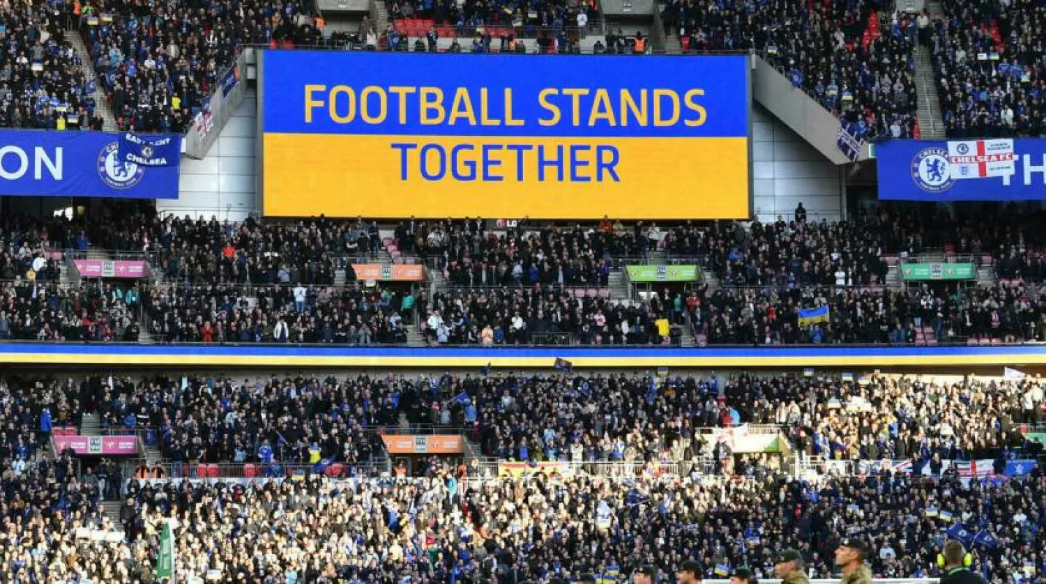 A 'Football Stands Together' message is displayed in Ukrainian colors ahead of the English League Cup final football match between Chelsea and Liverpool at Wembley Stadium. JUSTIN TALLIS AFP
