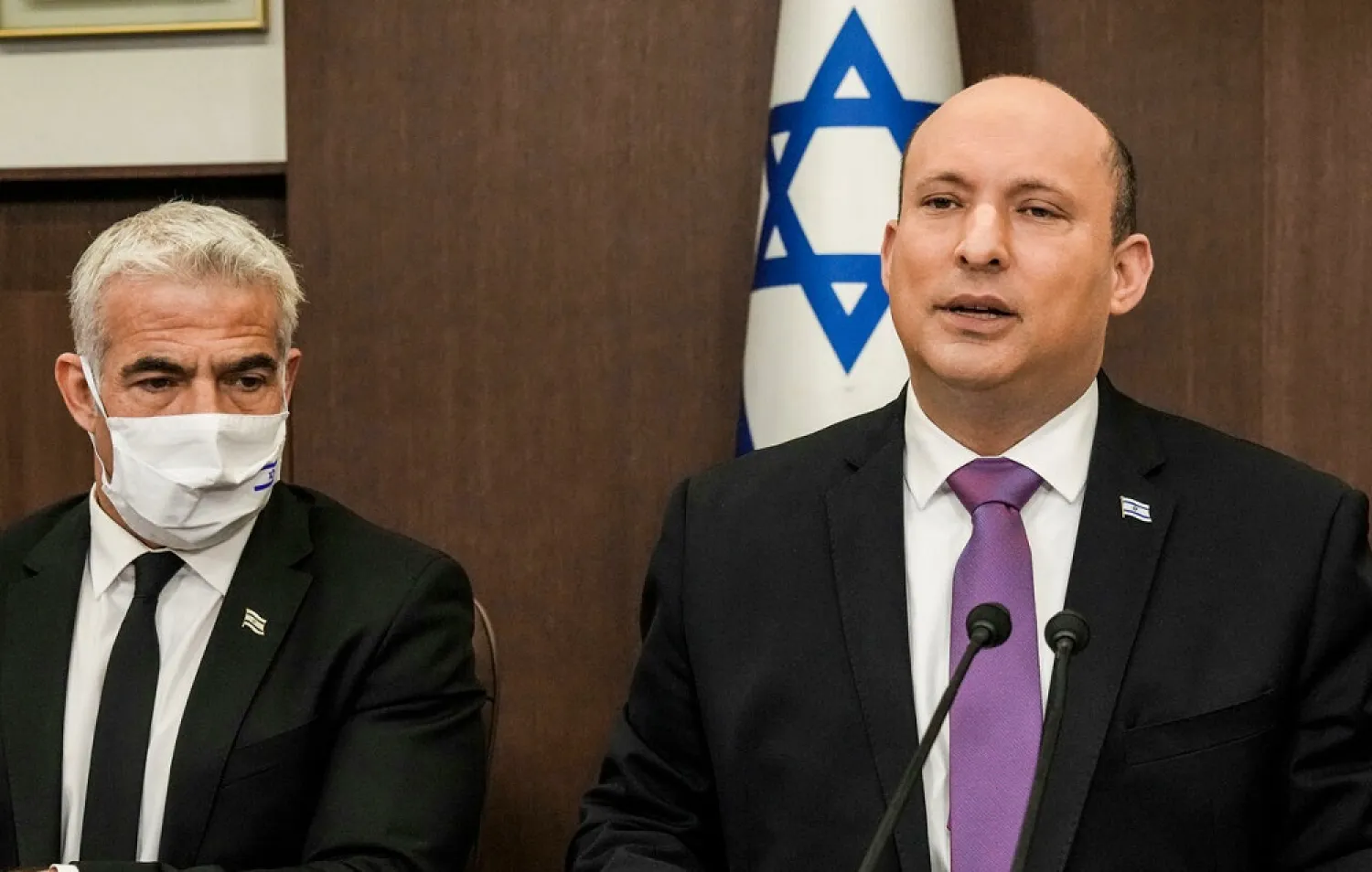 Israeli Prime Minister Naftali Bennett and Foreign Minister Yair Lapid at a cabinet meeting last month. (AFP)