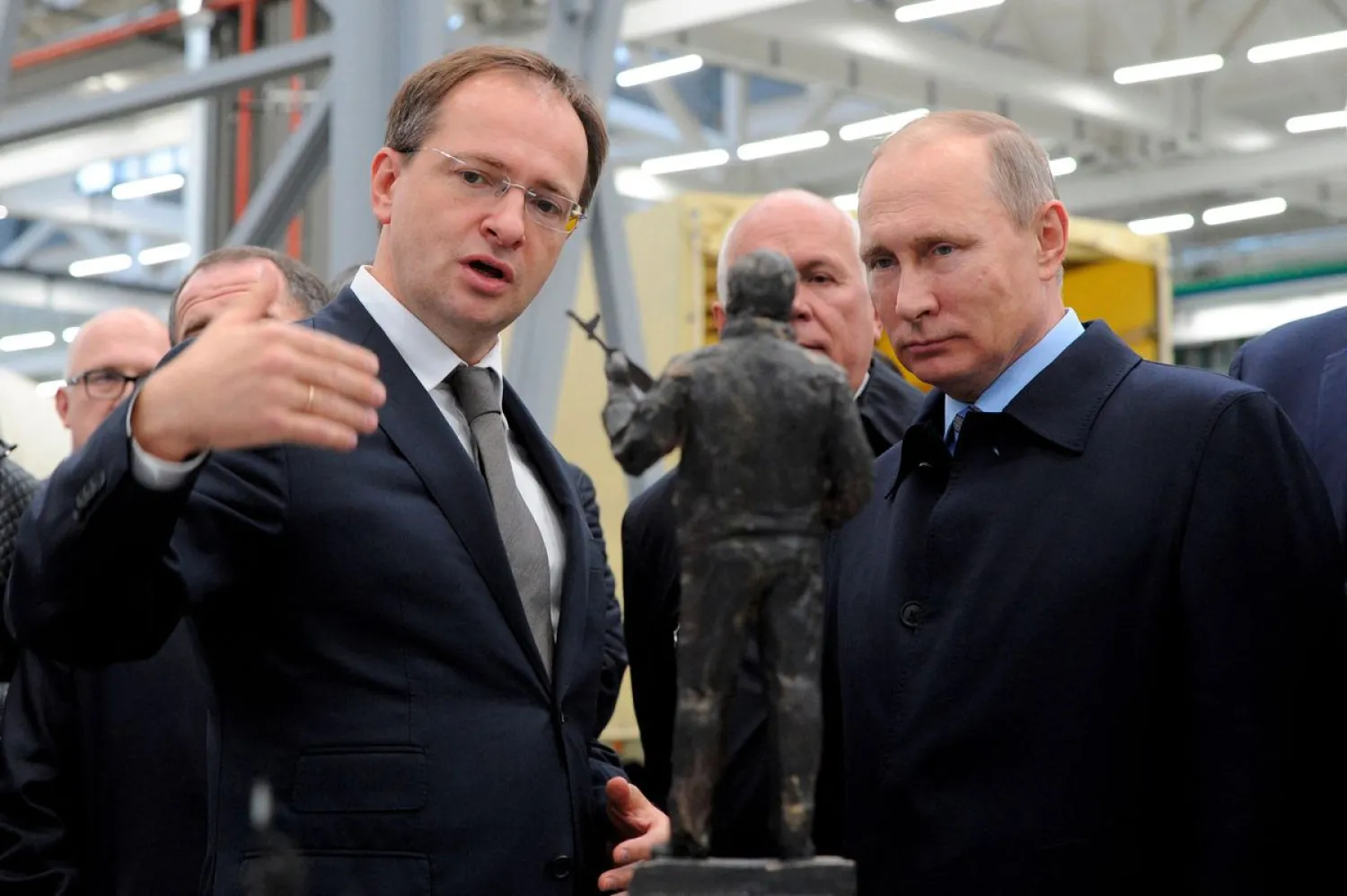 Russian President Vladimir Putin (R) listens to Culture Minister Vladimir Medinsky as they watch the project of a monument to Mikhail Kalashnikov, the Russian inventor of the AK-47 assault rifle, during a visit at firearms maker Kalashnikov Concern in Izhevsk, Russia, September 20, 2016. (Reuters)