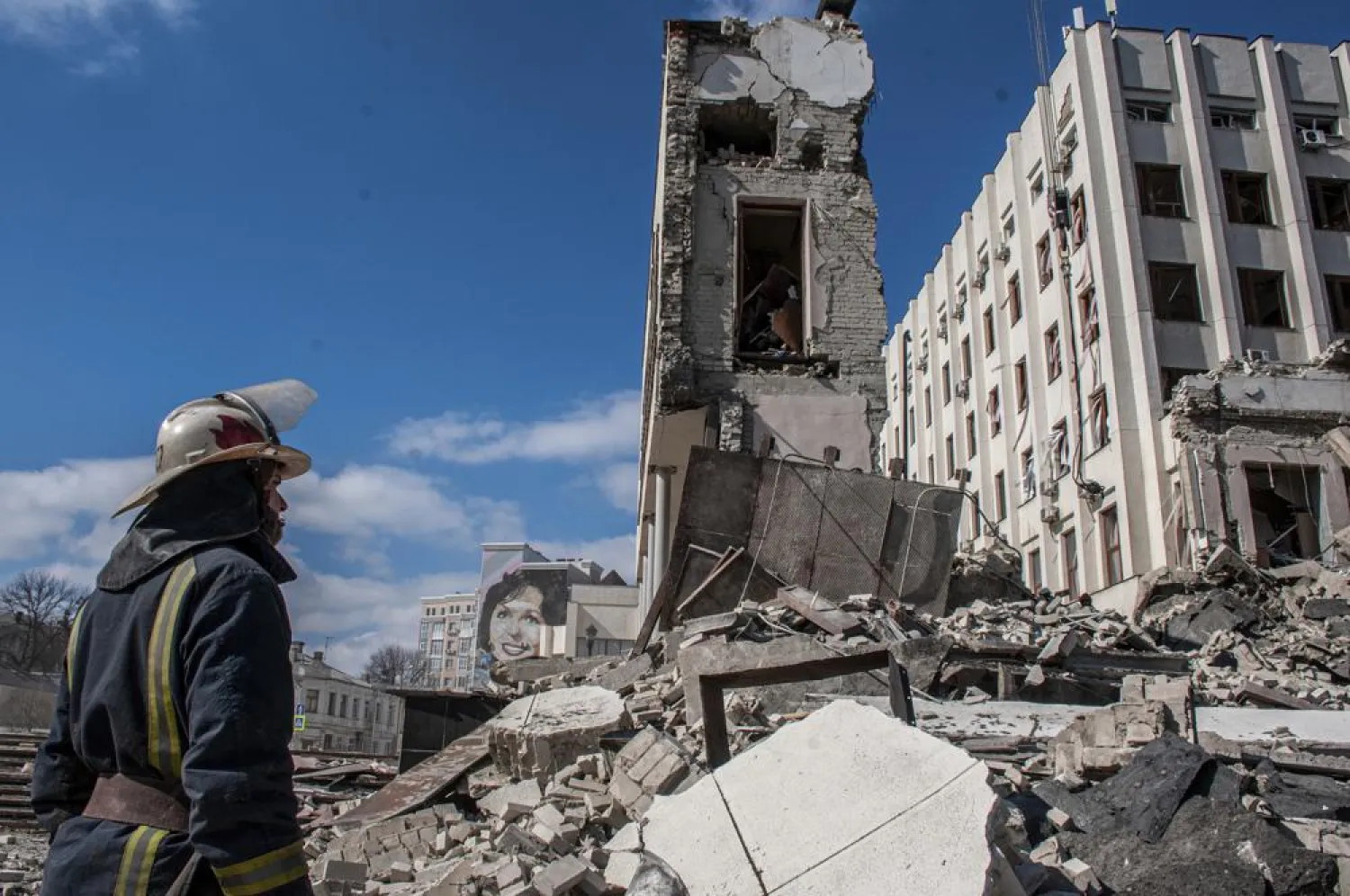 Rescuers work at the site of the National Academy of State Administration building damaged by shelling in Kharkiv, Ukraine, Friday, March 18, 2022. (AP Photo/Andrew Marienko)
