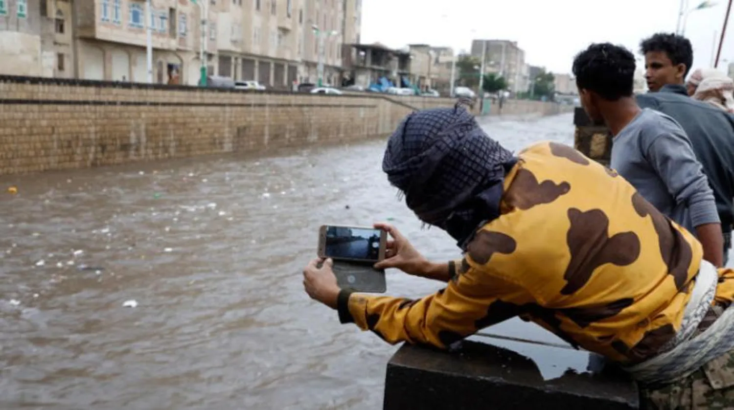 Yemeni resident documenting the recent floods that hit Sanaa (EPA)
