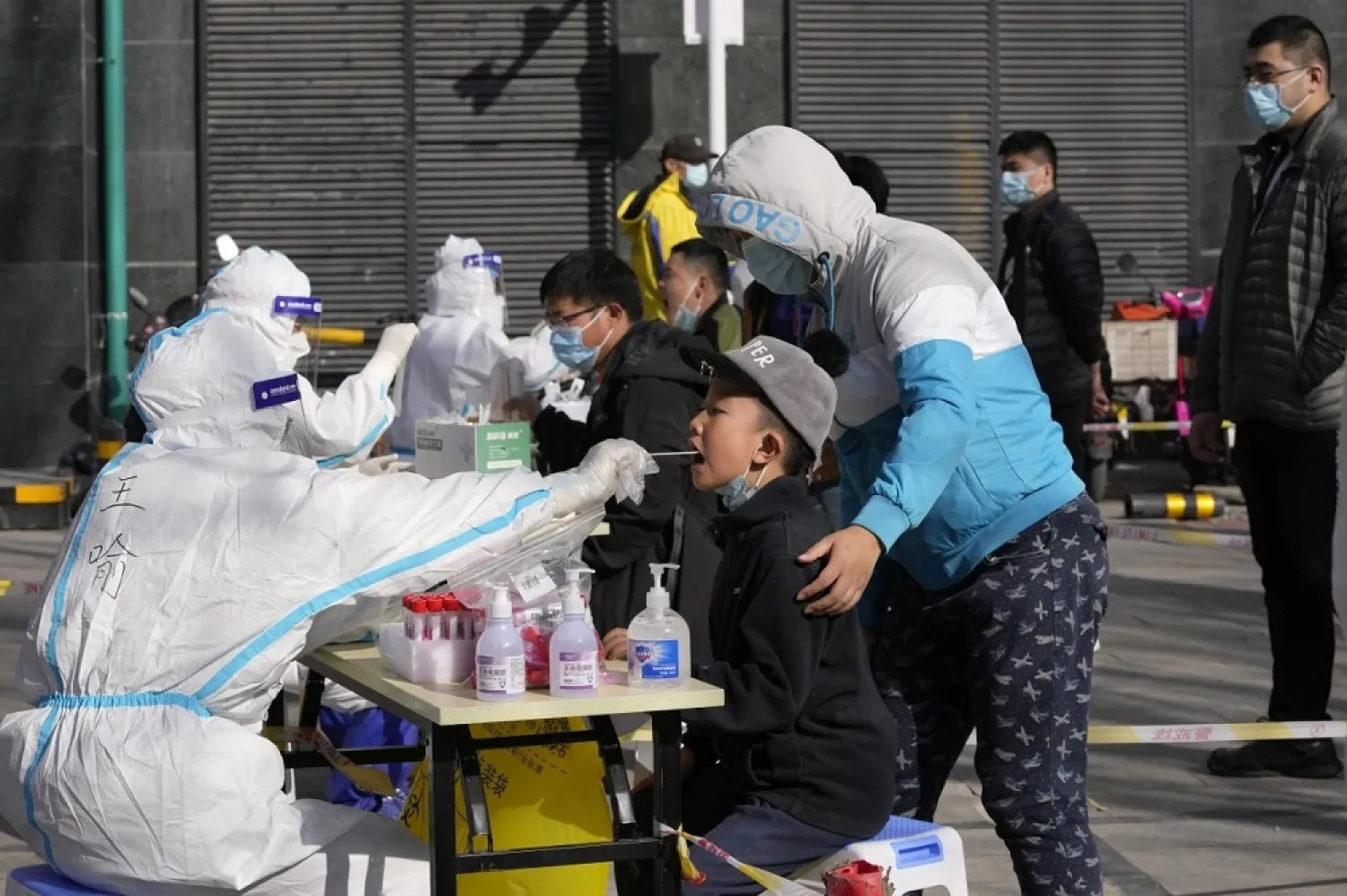 Residents get tested for the coronavirus at an outdoor facility in Beijing on Monday. (AP)