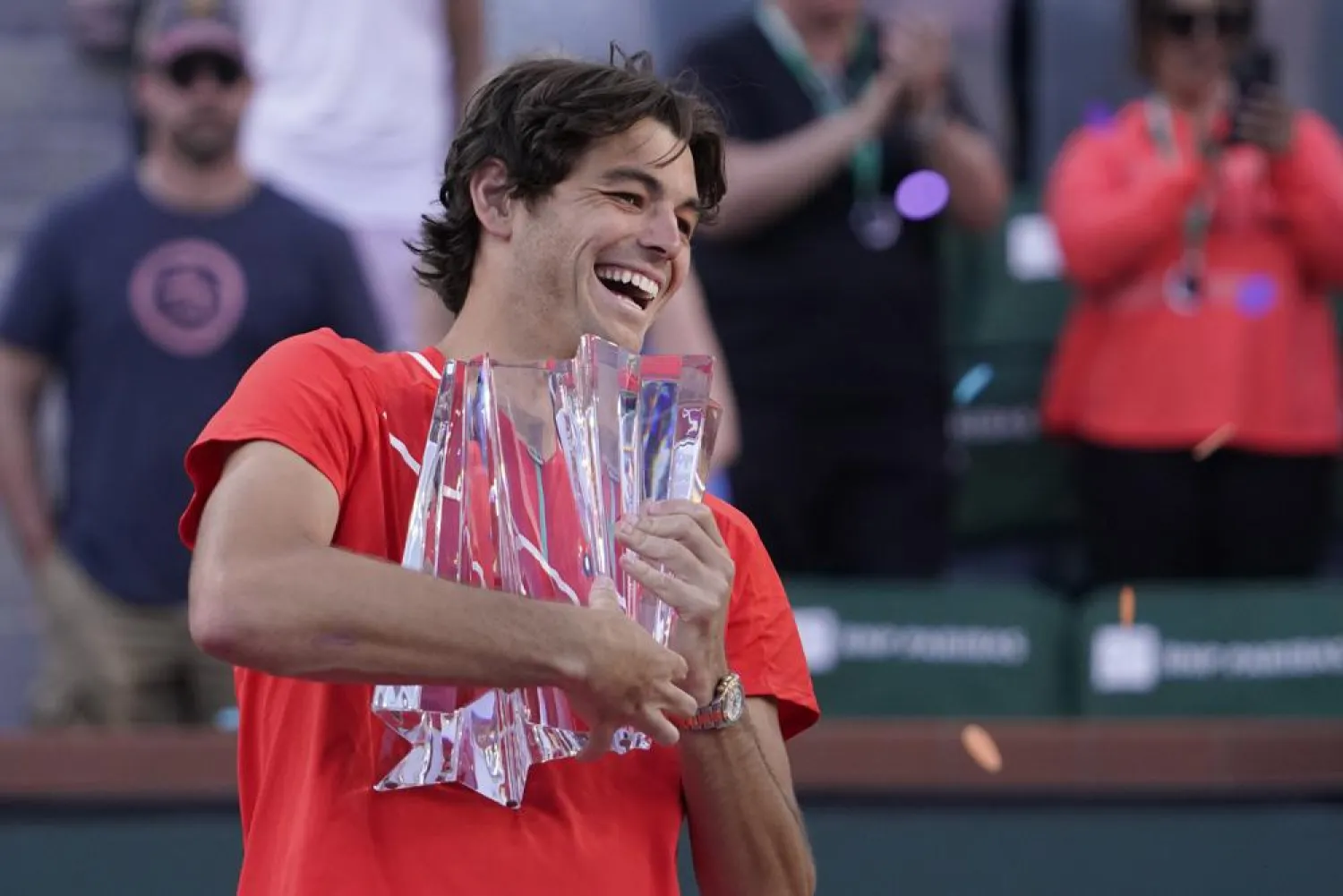 Taylor Fritz holds up his trophy after defeating Rafael Nadal, of Spain, after the men's singles finals at the BNP Paribas Open tennis tournament Sunday, March 20, 2022, in Indian Wells, Calif. Fritz won 6-3, 7-6. (AP)