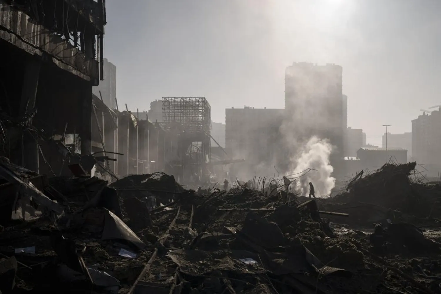 Firefighters extinguish a fire near a shopping center after shelling, in Kyiv, Ukraine, Monday, March 21, 2022. (AP)