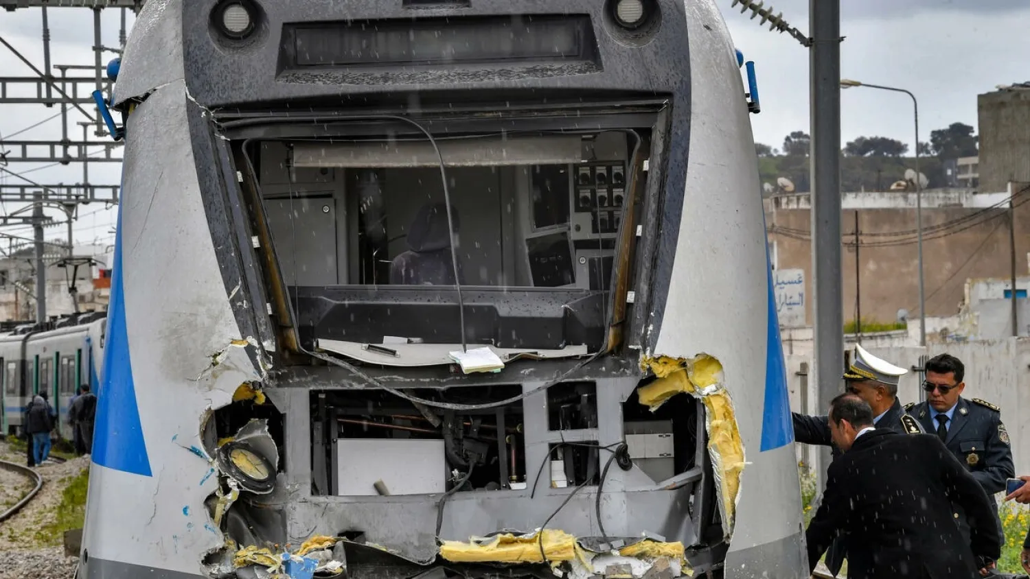  Police inspect the damage to one of the locomotives in a train collision in the Jbel Jelloud area in the south of Tunisia's capital Tunis on March 21, 2022. (AFP)