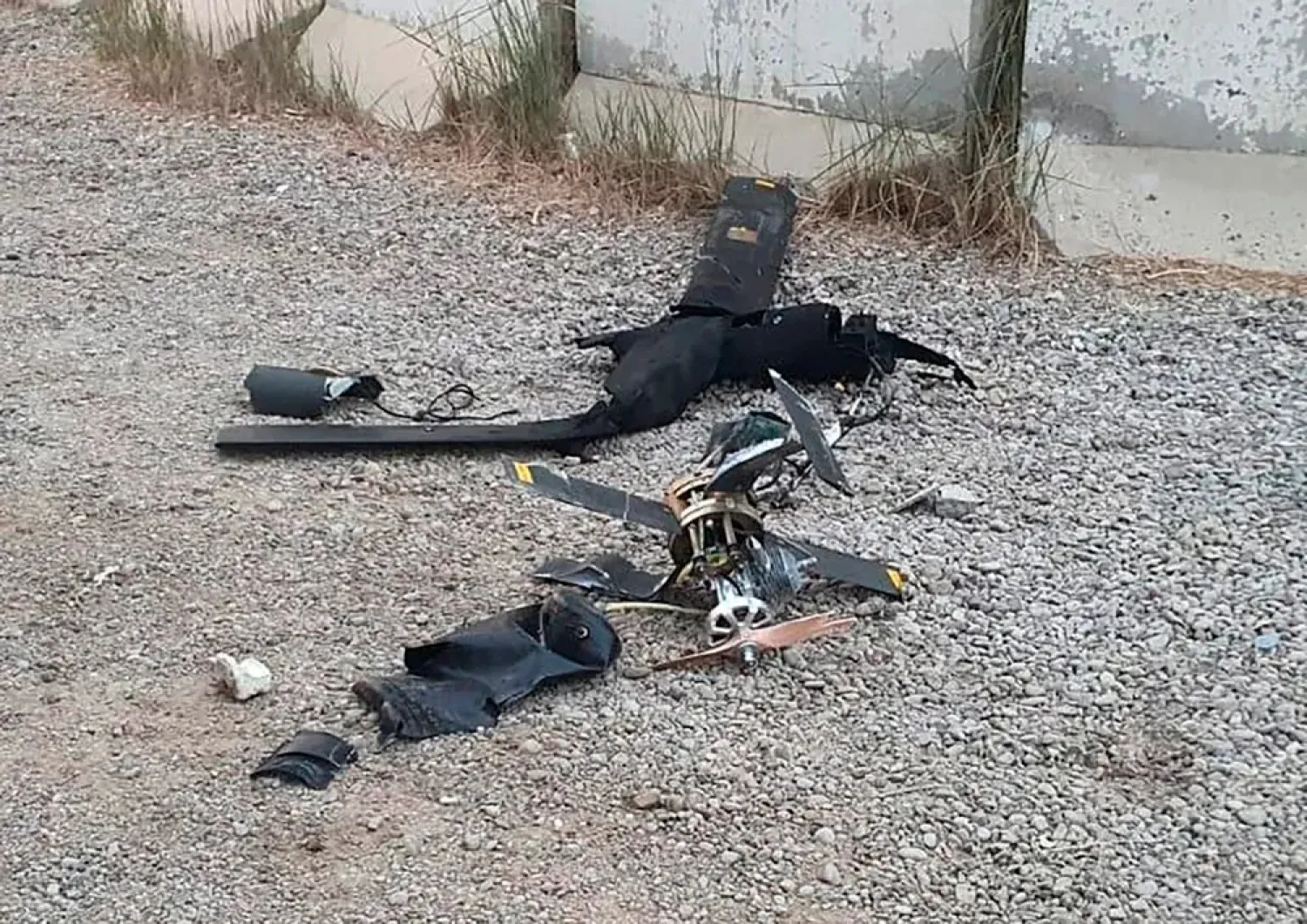Parts of the wreckage of a drone lie on the ground at the airport in Baghdad, Iraq, January 3, 2022. (International Coalition via AP)