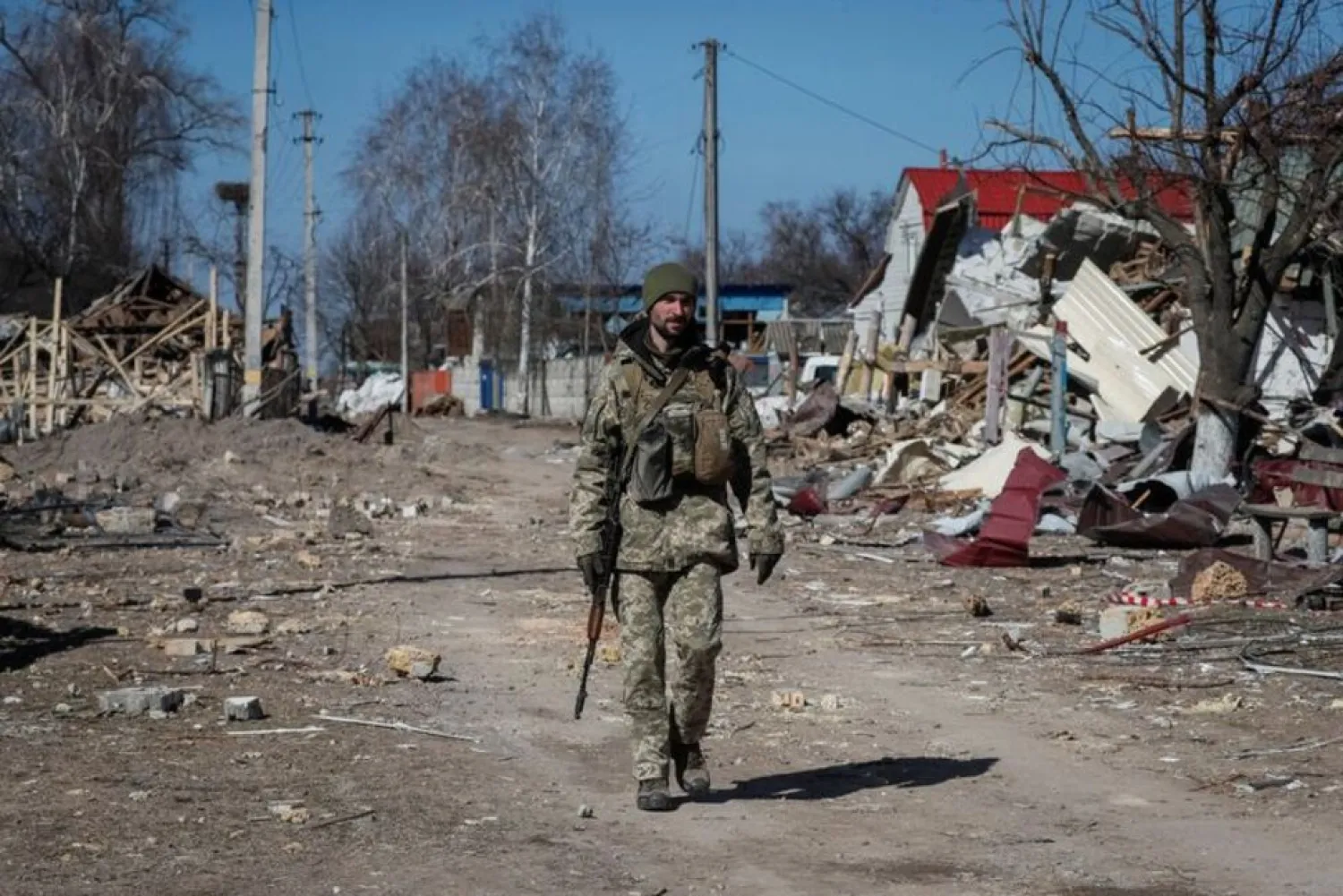 A Ukrainian service member walks, as the Russian invasion continues, in a destroyed village on the front line in the east Kyiv region, Ukraine March 21, 2022. (Reuters)