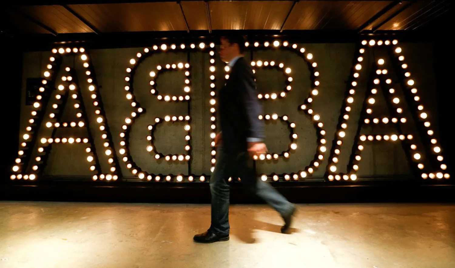 A man walks past the lit logo of the legendary Swedish pop group ABBA at the new "ABBA - The Museum" in Stockholm, Sweden May 6, 2013. (Reuters)