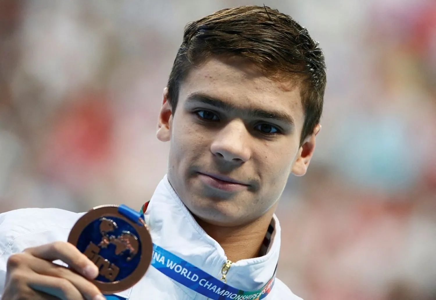 Russia's Evgeny Rylov celebrates with his bronze medal after the men's 200m backstroke final at the Aquatics World Championships in Kazan, Russia August 7, 2015. (Reuters)