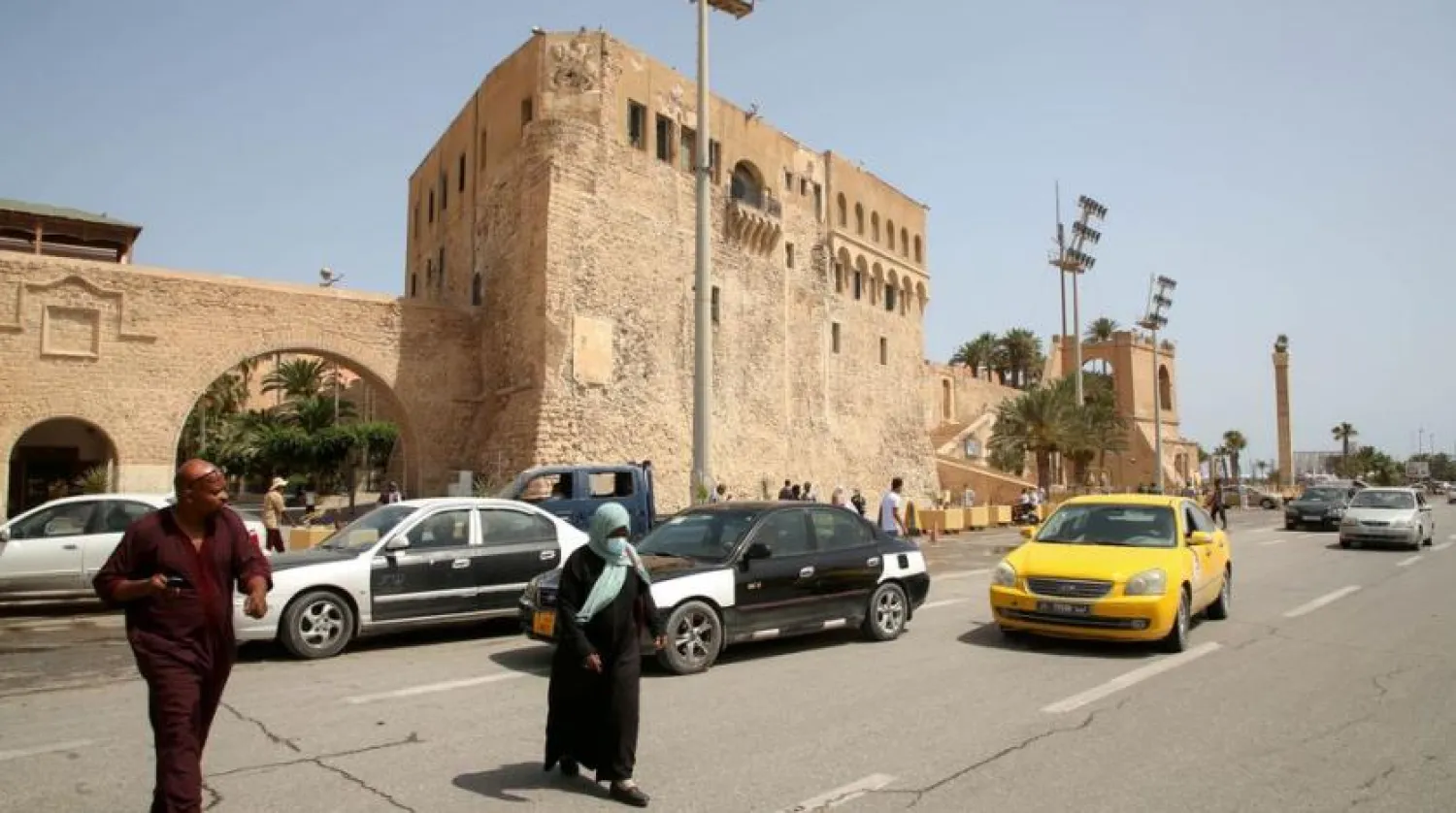 People cross a street at Martyrs Square in Tripoli, Libya, July 5, 2021. (Reuters)
