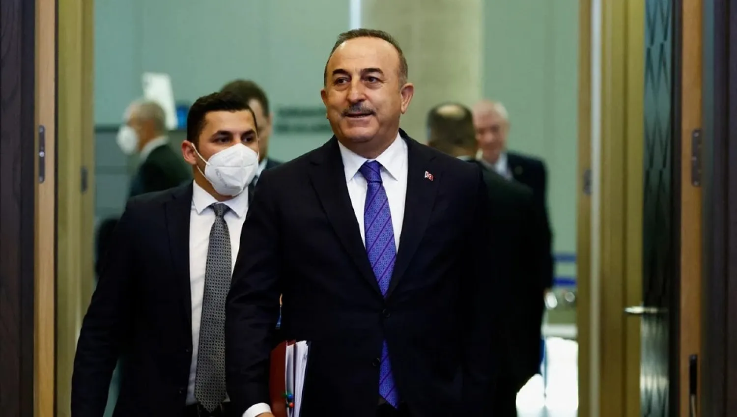 Turkish Foreign Minister Mevlut Cavusoglu walks in to attend a NATO summit to discuss Russia's invasion of Ukraine, at the alliance's headquarters in Brussels, Belgium, March 24, 2022. (Reuters)