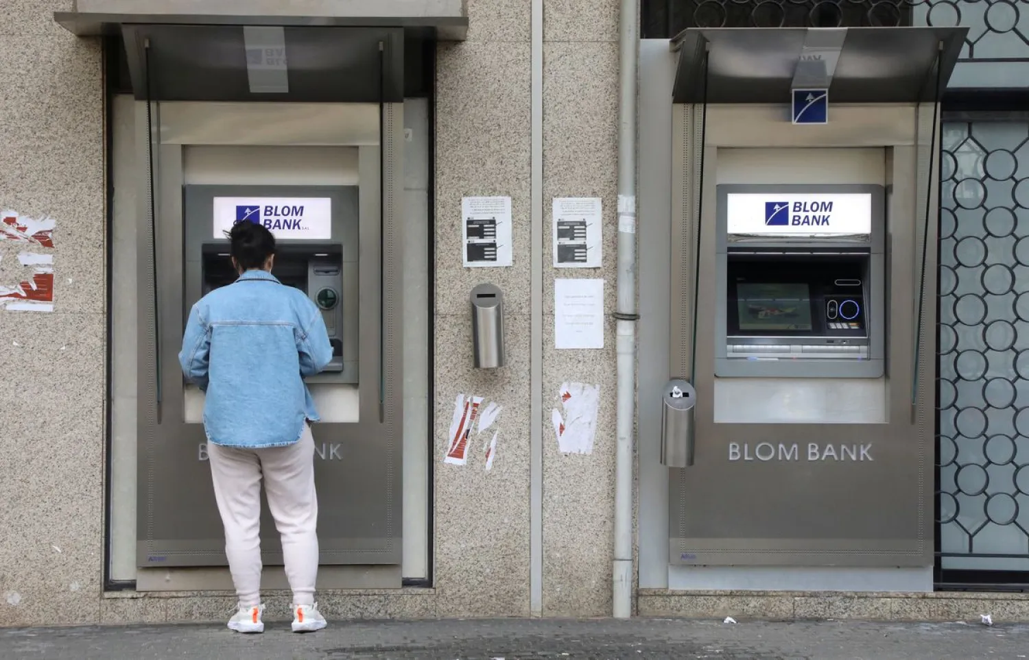 A woman uses a Blom Bank ATM machine in Beirut, Lebanon March 18, 2022. Picture taken March 18, 2022. (Reuters)