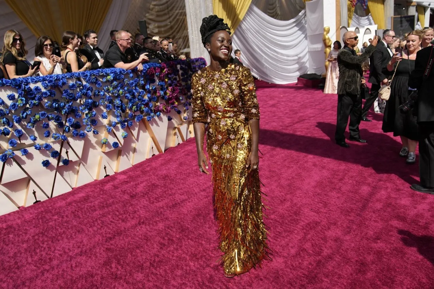 Lupita Nyong'o dazzles in gold at the Oscars red carpet. (AP)