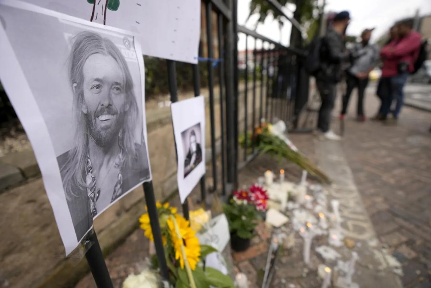 An image of Foo Fighters' drummer Taylor Hawkins adorns a makeshift memorial outside the hotel where Hawkins was found dead, in northern Bogota, Colombia, Saturday, March 26, 2022. (AP)