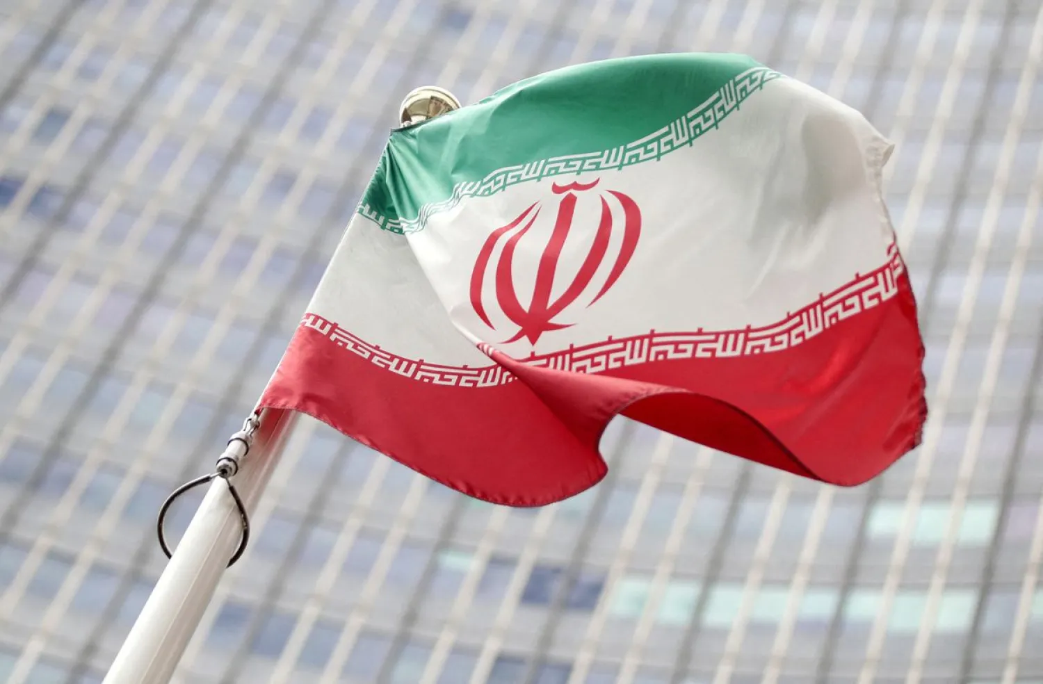The Iranian flag flutters in front the International Atomic Energy Agency (IAEA) headquarters in Vienna, Austria July 10, 2019. (Reuters)