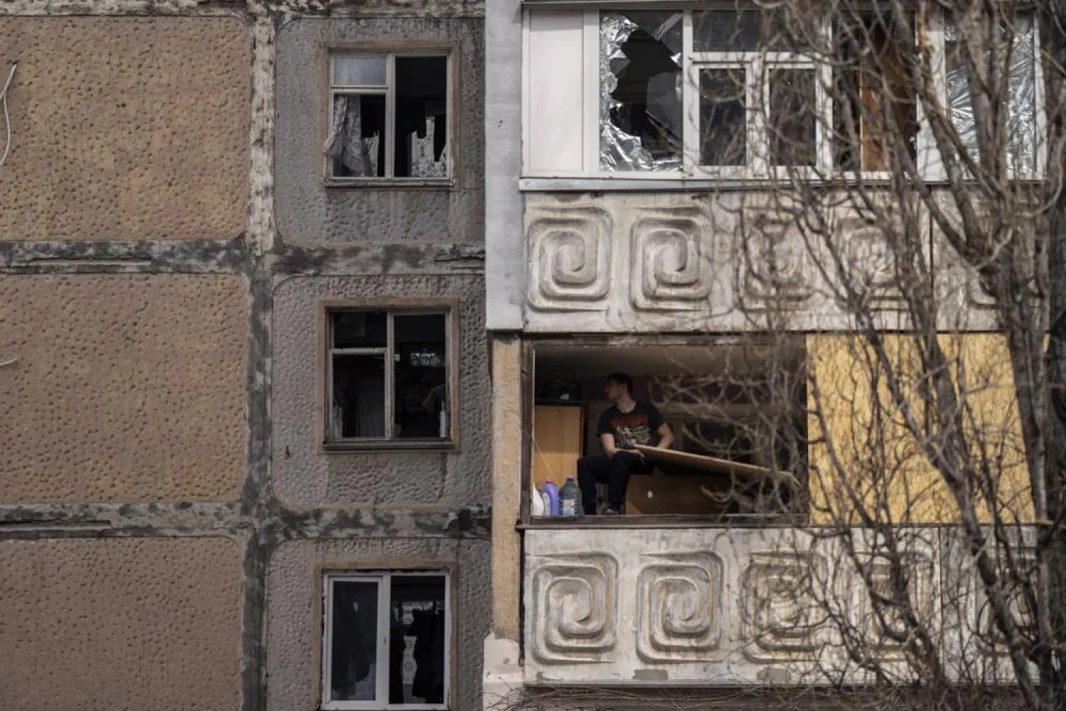 A man sits in a damaged flat of a building after a Russian attack on the previous night, at the residential area in Mikolaiv, Ukraine, on Tuesday, March 29, 2022. (AP)