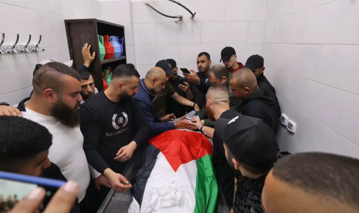 Palestinian mourners surround the body of Sanad Abu Atiyeh at a hospital in the town of Jenin on March 31, 2022 JAAFAR ASHTIYEH AFP
