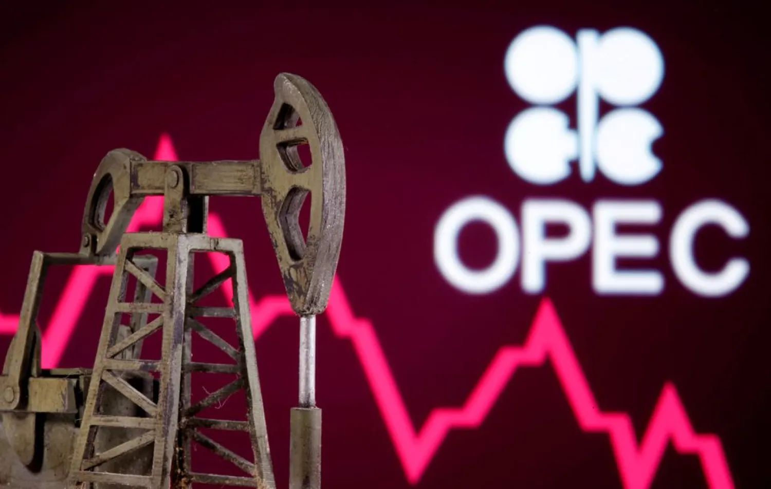 A 3D printed oil pump jack is seen in front of displayed stock graph and Opec logo in this illustration picture, April 14, 2020. REUTERS/Dado Ruvic/Illustration