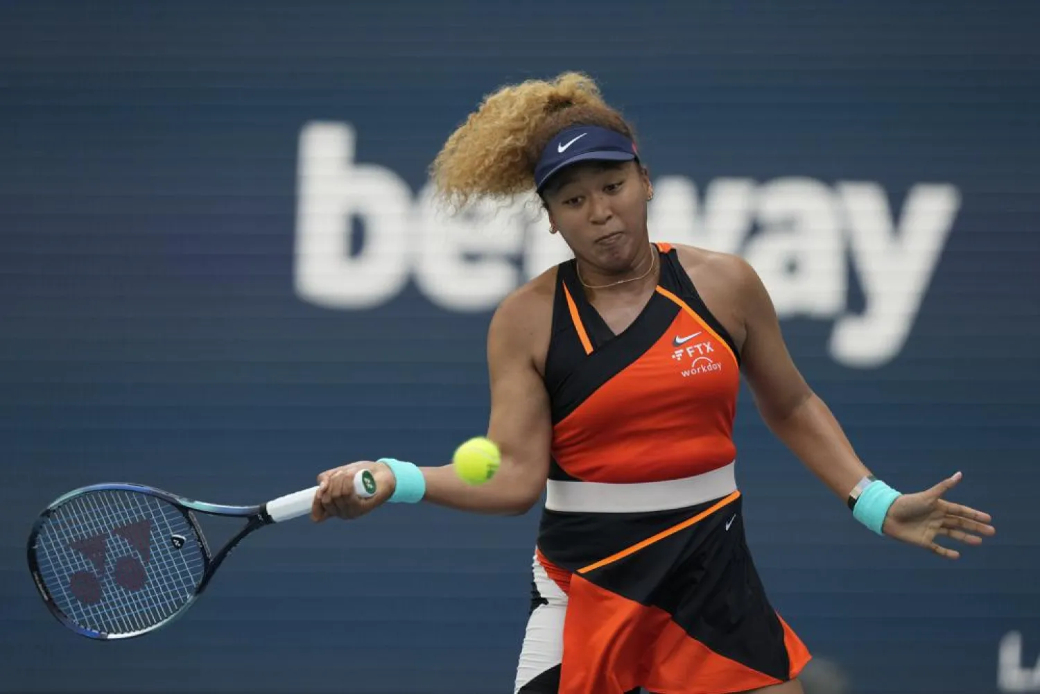 Naomi Osaka of Japan plays a ball in her women's semifinal match against Belinda Bencic of Switzerland, at the Miami Open tennis tournament, Thursday, March 31, 2022, in Miami Gardens, Fla. (AP)