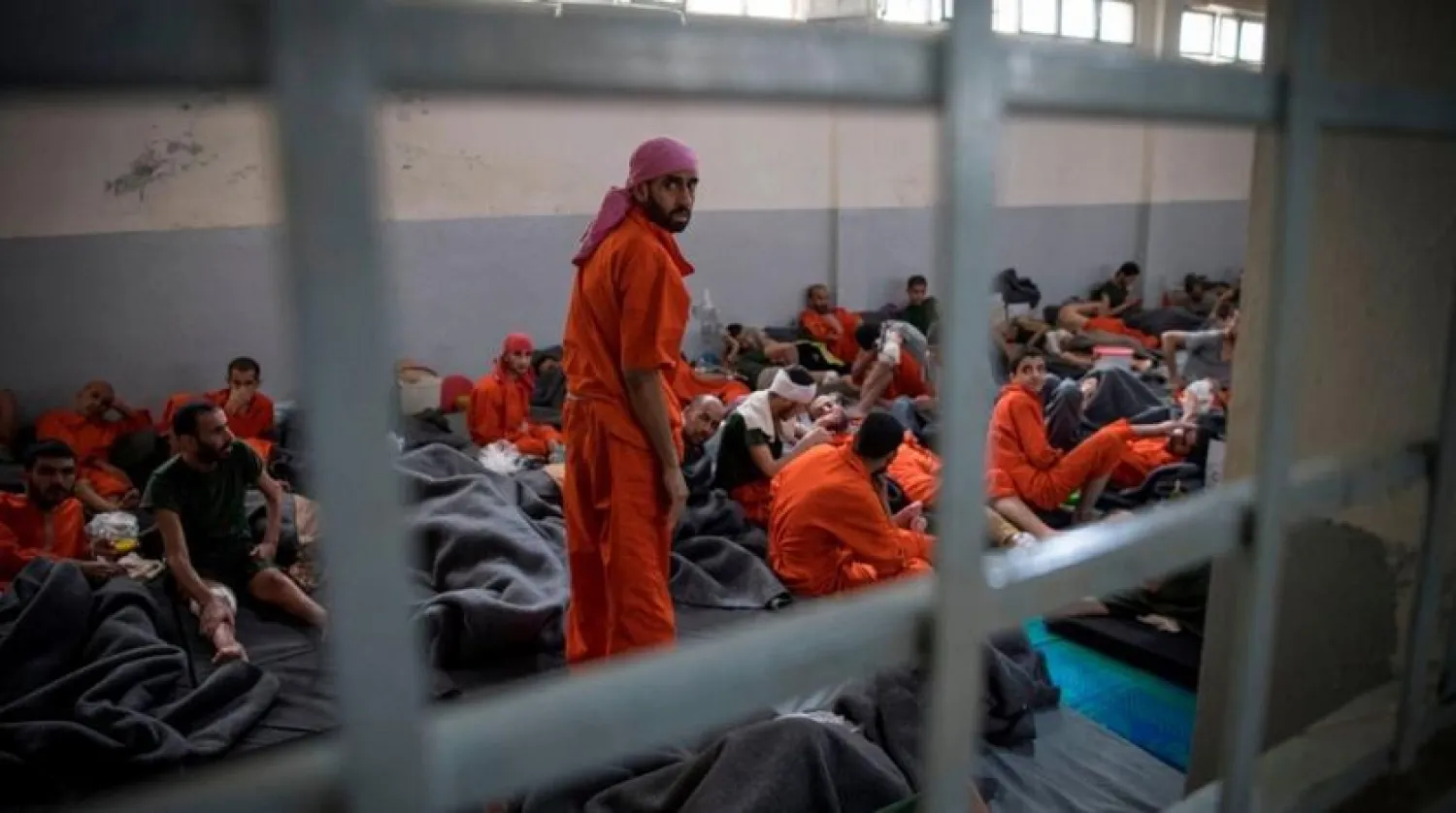 Men allegedly affiliated with the ISIS group sit on the floor in a prison in the northeastern Syrian city of al-Hasaka on Oct. 26, 2019. (Getty Images) 