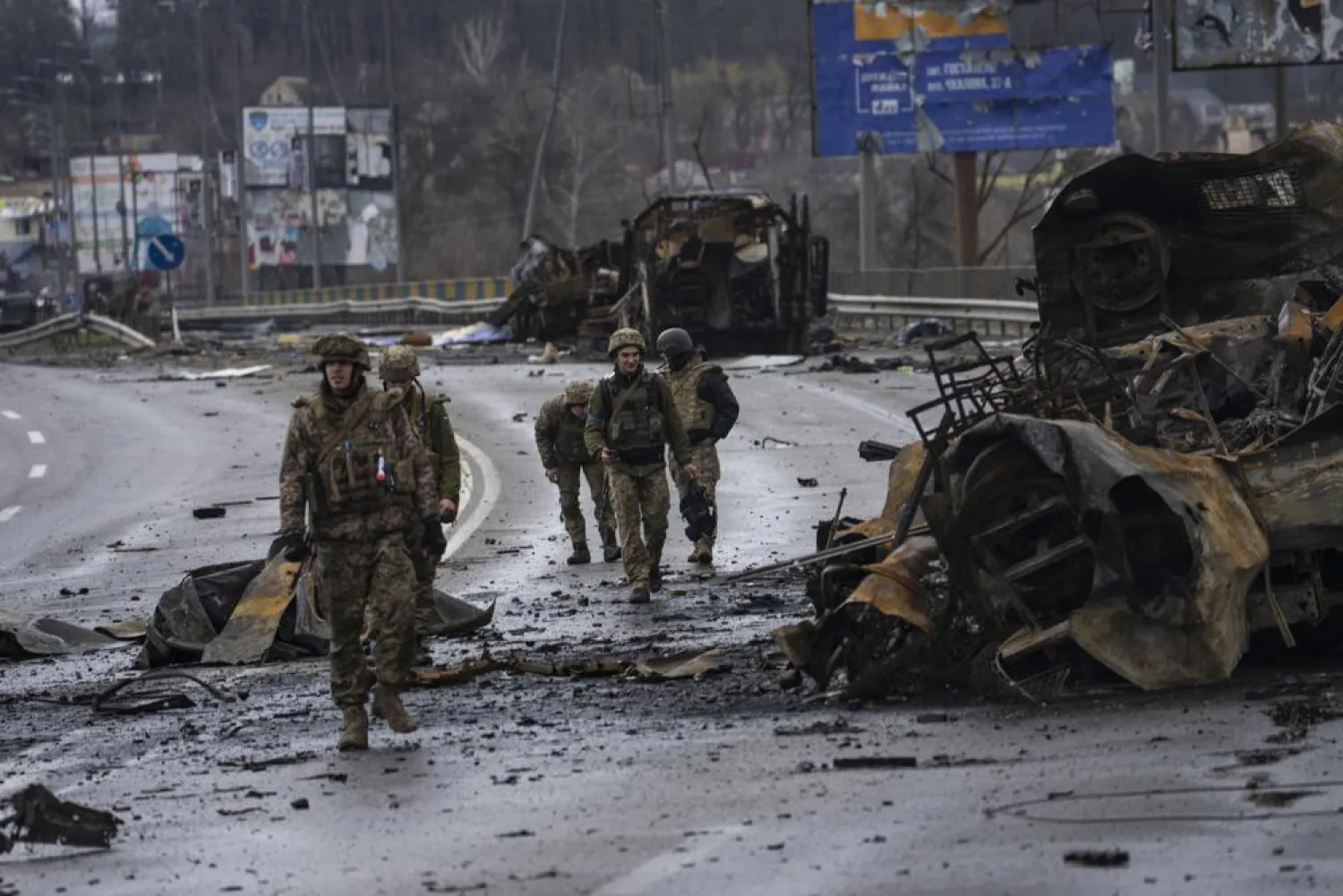 Ukrainian soldiers walk next to destroyed Russians armored vehicles in Boucha, Ukraine, Saturday, April 2, 2022. (AP)