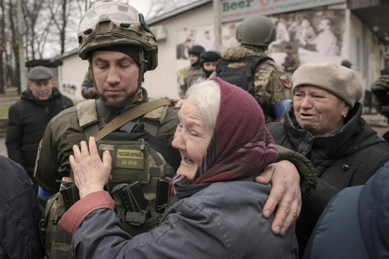 A woman hugs a Ukrainian serviceman after a convoy of military and aid vehicles arrived in the formerly Russian-occupied Kyiv suburb of Bucha, Ukraine, Saturday, April 2, 2022. (AP)