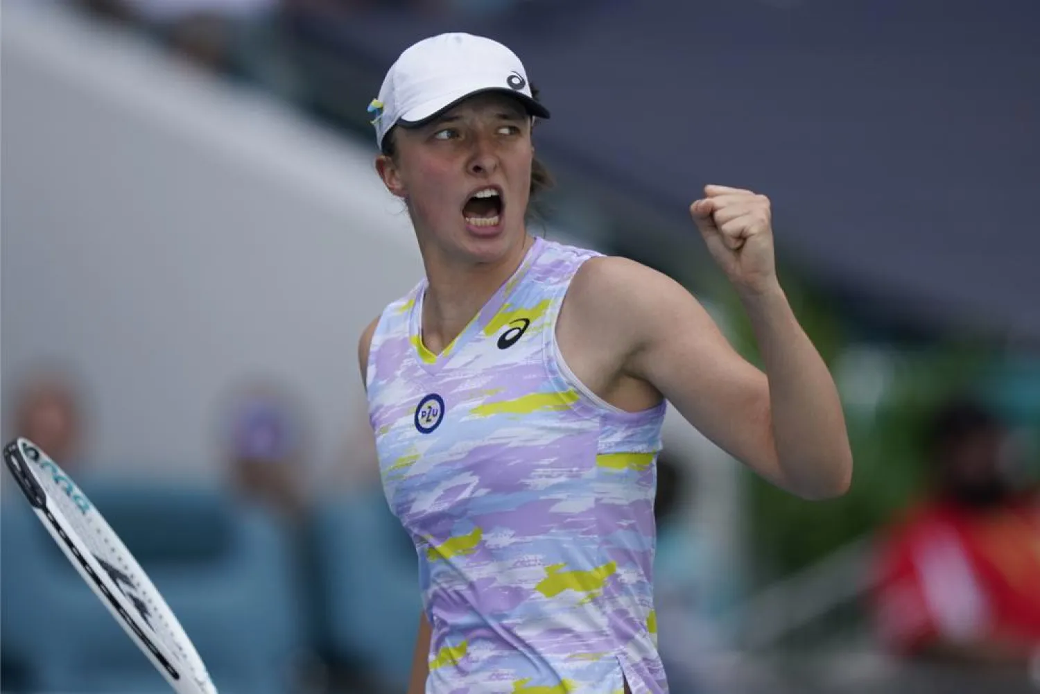Iga Swiatek of Poland celebrates winning the first set against Naomi Osaka of Japan, during the women's singles finals of the Miami Open tennis tournament, Saturday, April 2, 2022, in Miami Gardens, Fla. (AP)