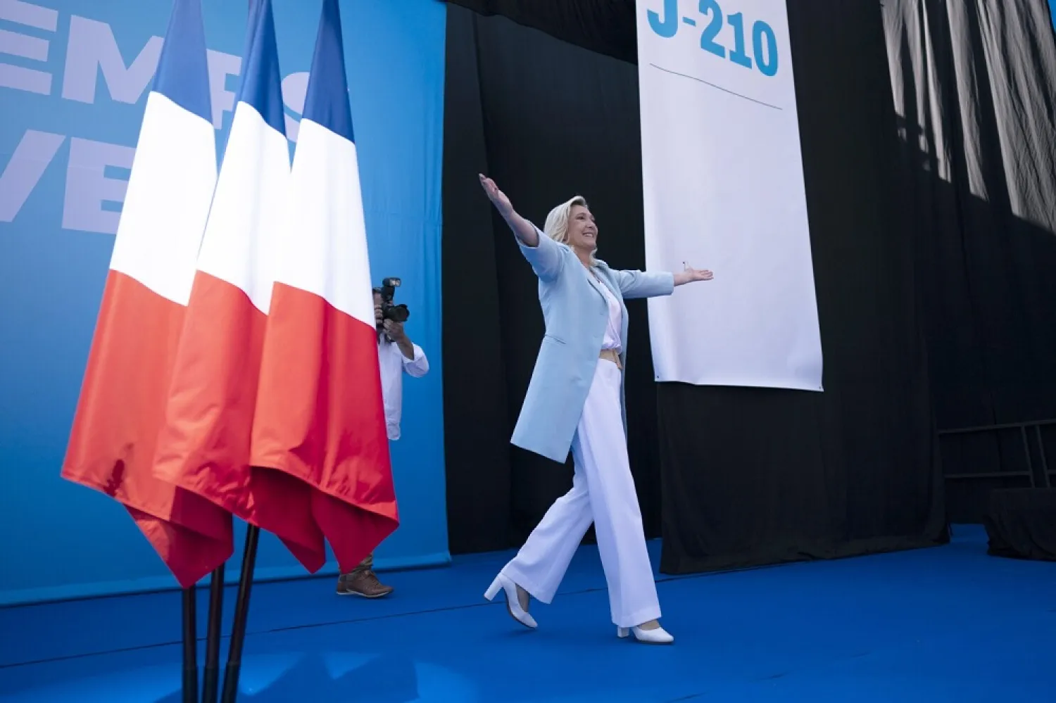 Marine Le Pen walks on stage, at a National Rally event in Frejus, Sunday, Sept. 12, 2021. (AP)