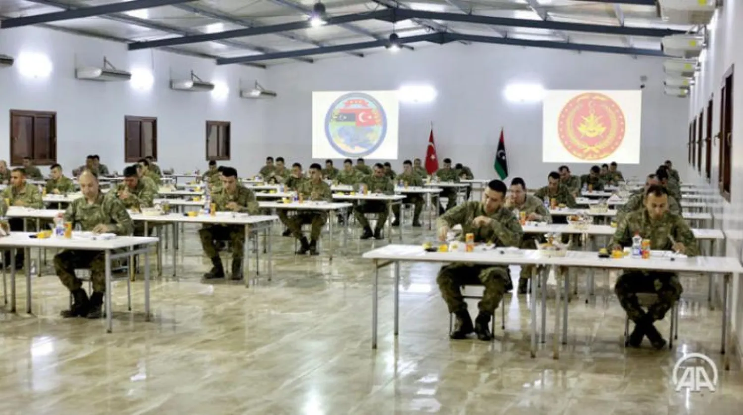 A picture released by the Turkish Anadolu news agency shows Turkish soldiers having the Suhoor meal in Tripoli. (Anadolu)