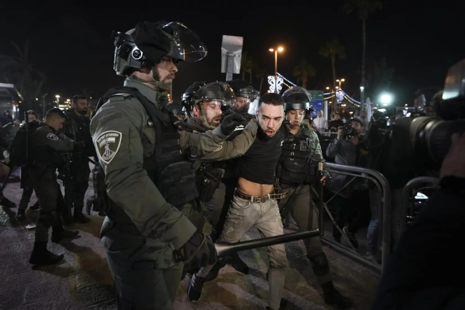 Israeli border police officers detain a protester during clashes between Israeli security forces and Palestinians next to Damascus Gate, outside the Old City of Jerusalem, during the Muslim holy month of Ramadan, Monday, April 4, 2022. (AP Photo/Mahmoud Illean)
