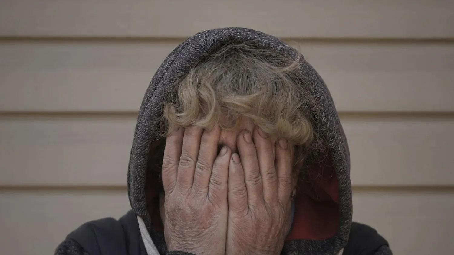 Natalya, whose husband and nephew were killed by Russian forces, cries in her garden in Bucha, Ukraine, Monday, April 4, 2022. (AP)
