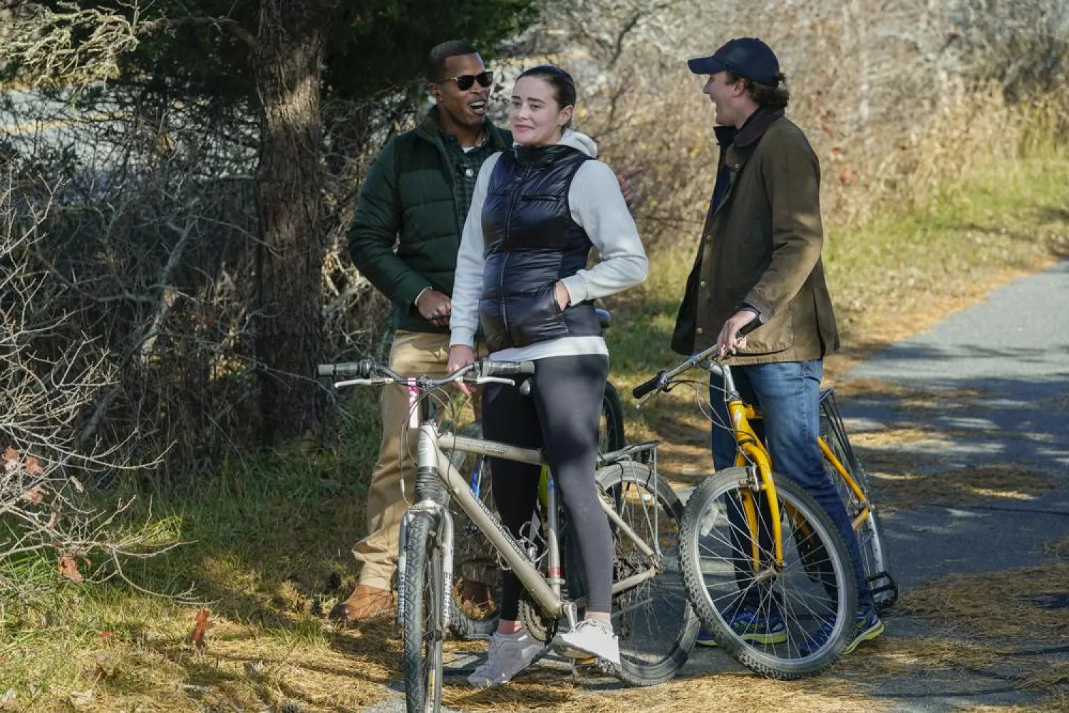 Naomi Biden, second from left, and her fiancé Peter Neal, right, stop on bikes in Nantucket, Mass., Nov. 25, 2021, for President Joe Biden and first lady Jill Biden to pass in a motorcade. (AP)