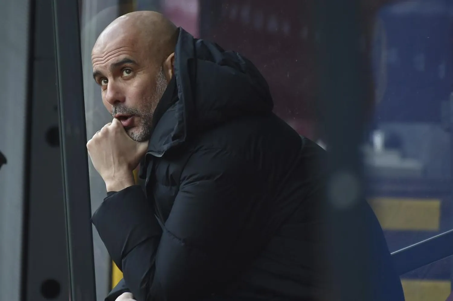 Manchester City's head coach Pep Guardiola sits on the bench before the Premier League match between Burnley and Manchester City at Turf Moor, in Burnley, England, Saturday, April 2, 2022. (AP)