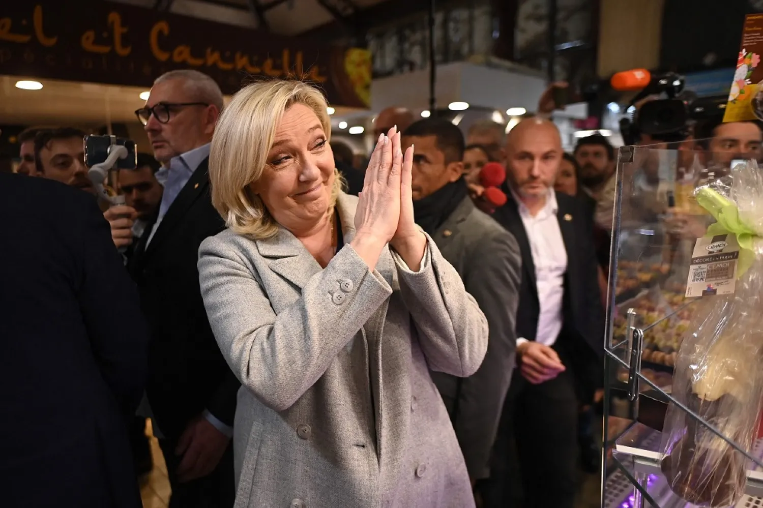 French far-right party Rassemblement National (RN) presidential candidate Marine Le Pen (C) gestures during a campaign trip in Narbonne, southern France, on April 8, 2022, two days before the French presidential election's first round. (AFP)